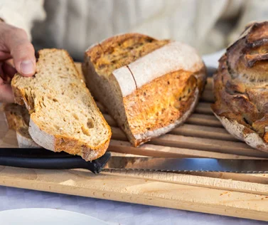 Hand breaking bread close-up